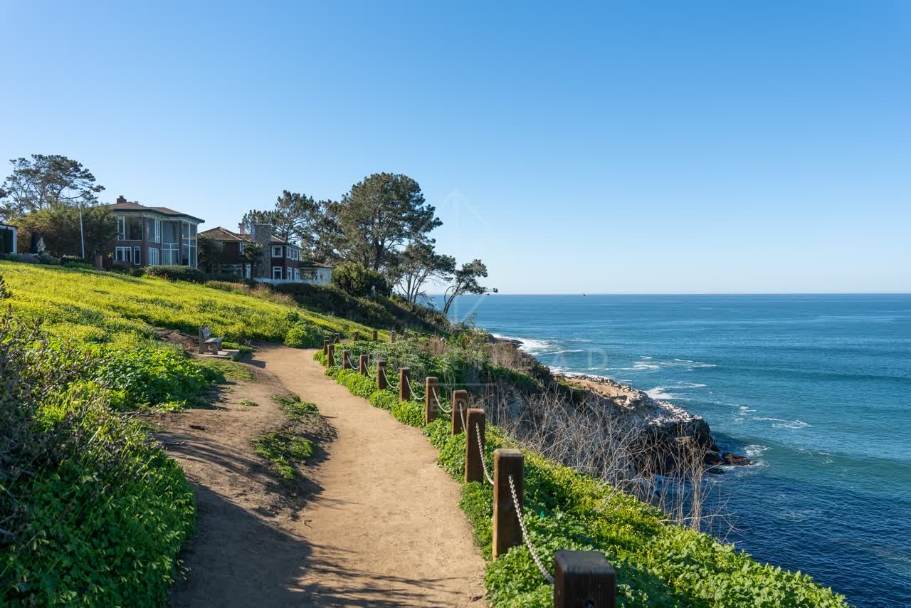 Elevated view of the cliffs, the ocean and homes at Coast Walk Trail.