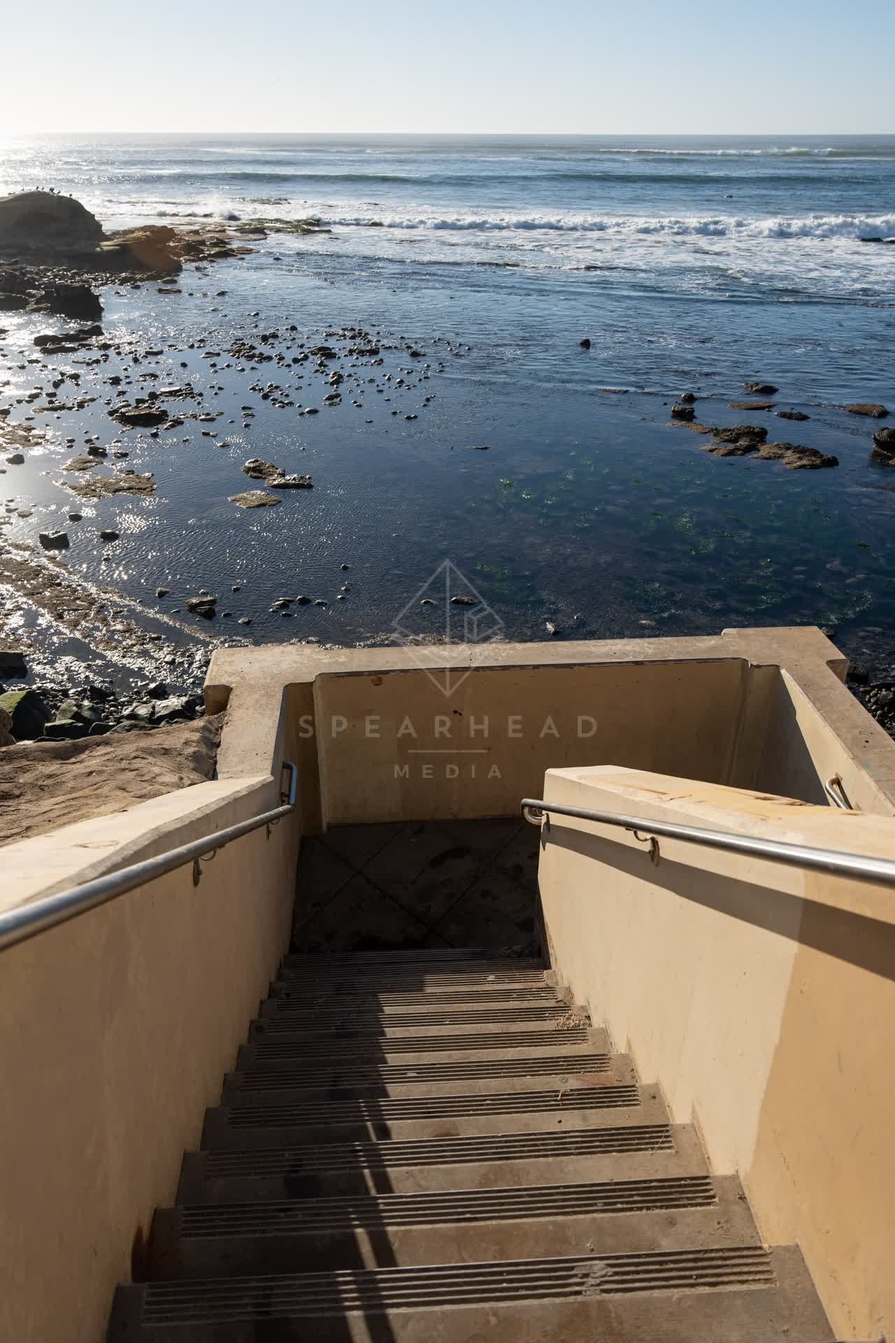 Elevated view of the cliffs, the surf and the ocean at Bird Rock.