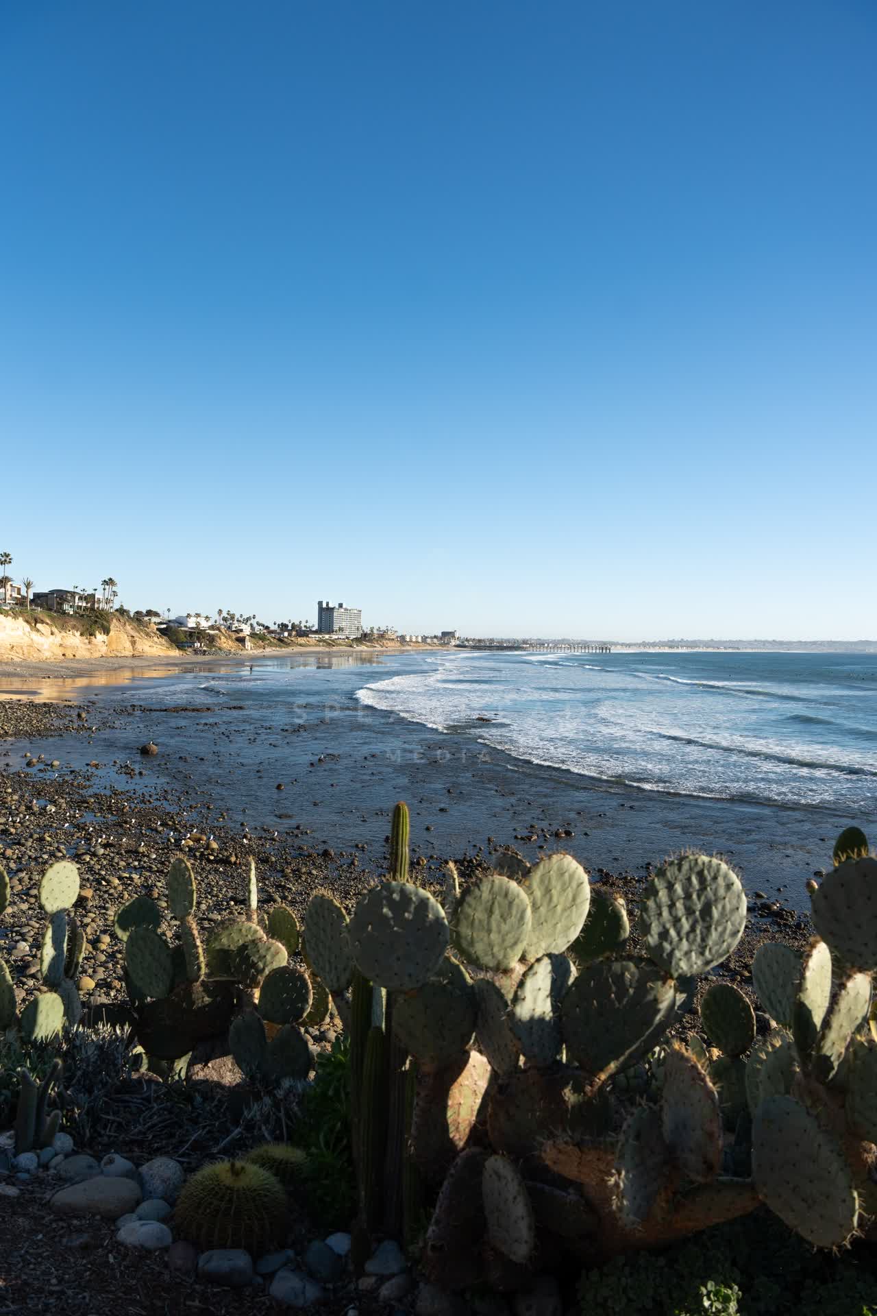 Elevated view of the cliffs, the surf and the pier at Bird Rock.