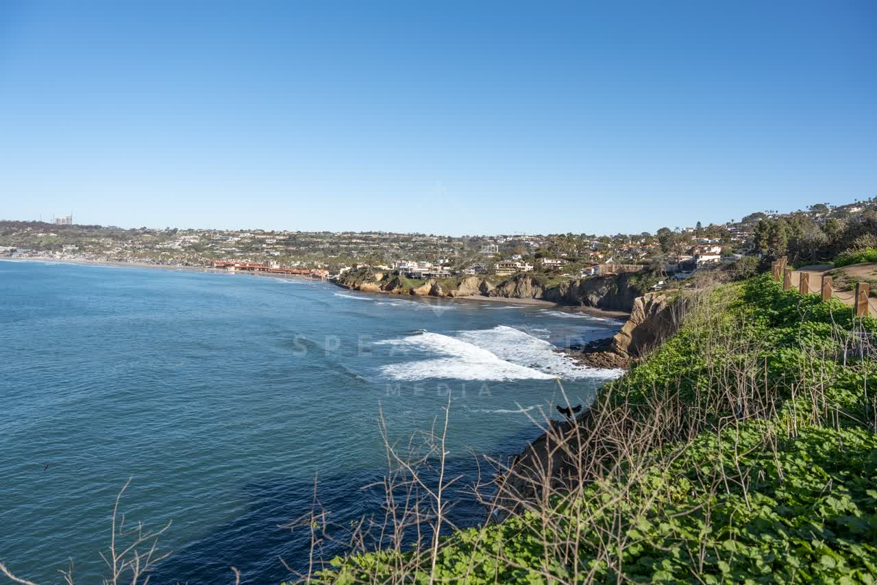Elevated view of the cliffs, the surf and the ocean at Coast Walk Trail.