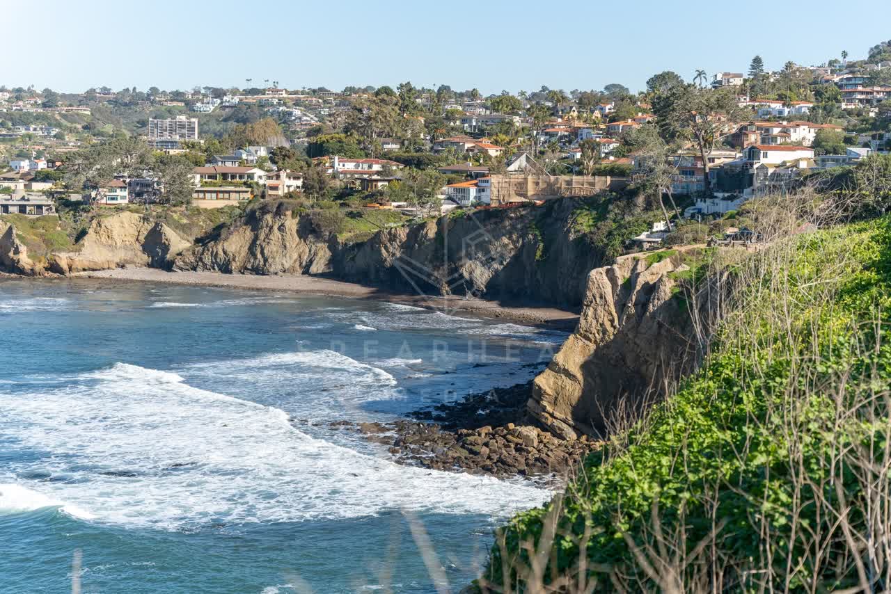 Elevated view of the cliffs, the surf and the ocean at Coast Walk Trail.