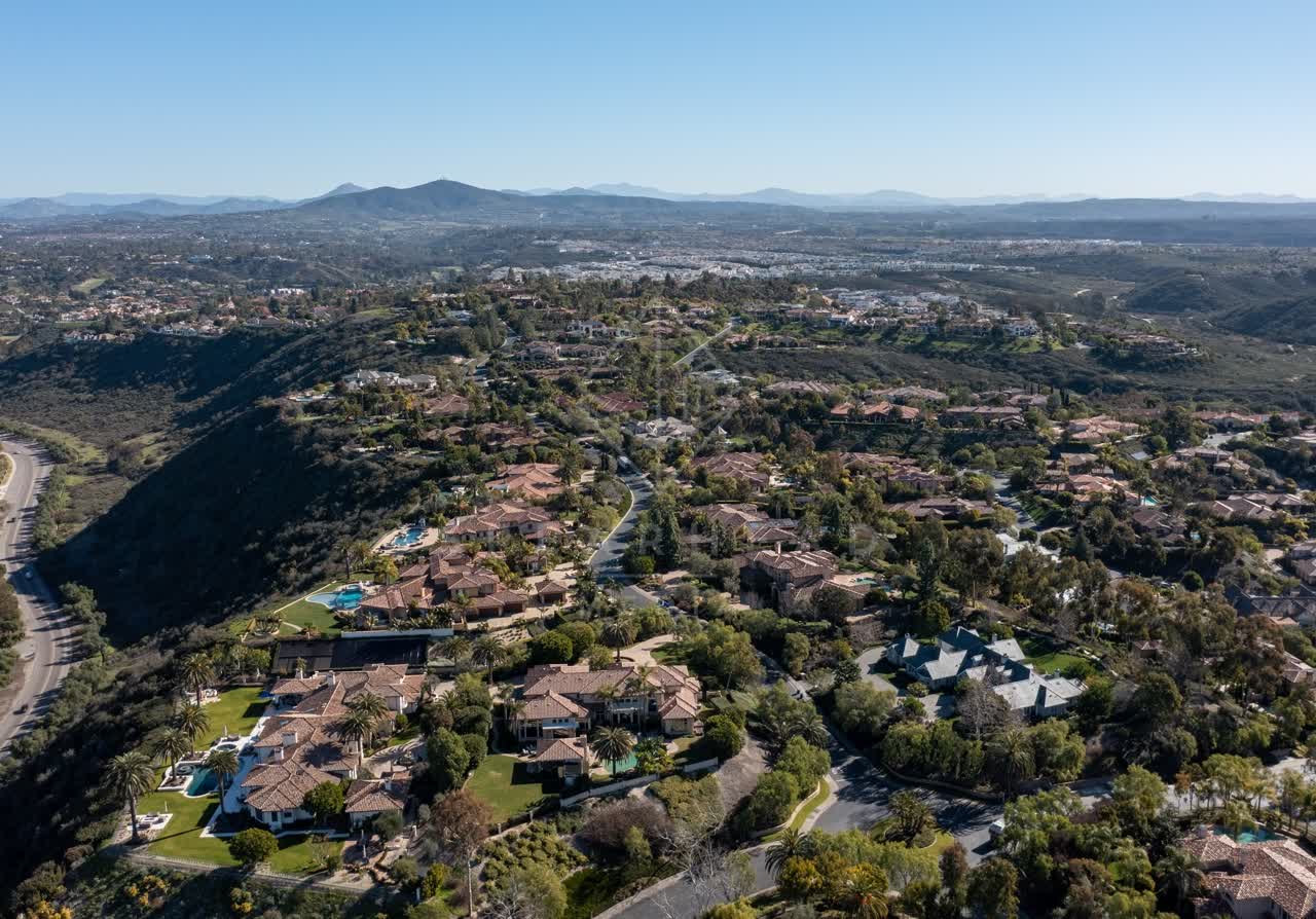 Aerial view of a residential street, palm trees and homes at Rancho Pacifica.
