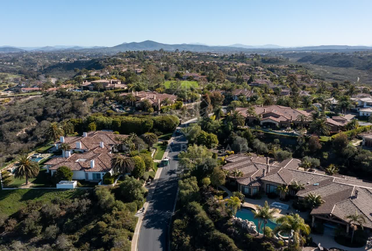 Aerial view of a residential street, palm trees and homes at Rancho Pacifica.