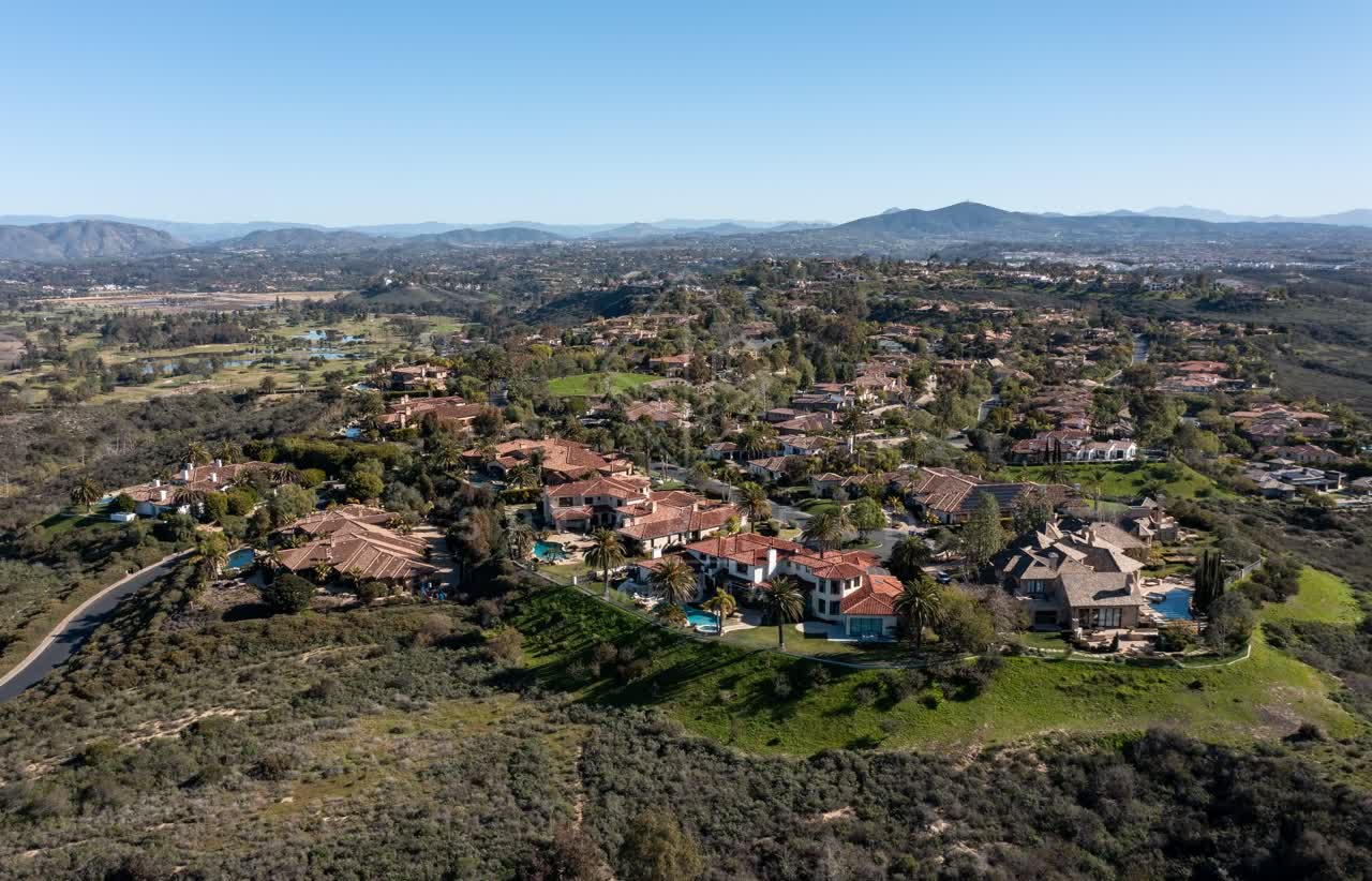 Aerial view of a residential street, palm trees and homes at Rancho Pacifica.