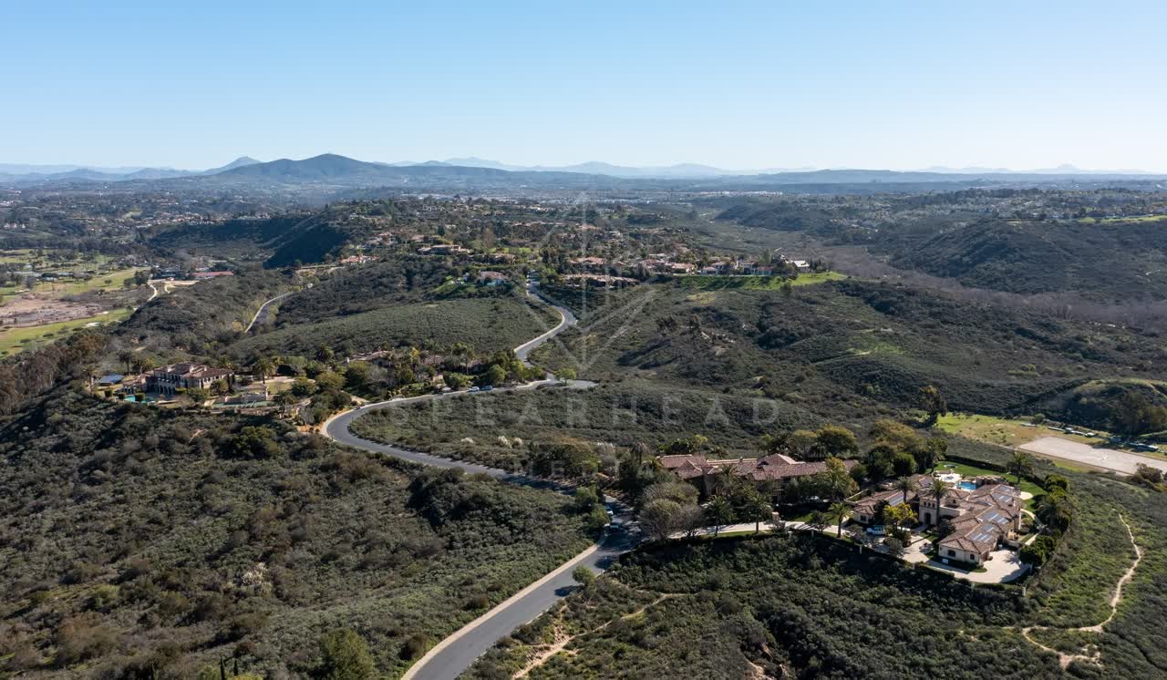 Aerial view of a residential street, homes and open country at Rancho Pacifica.