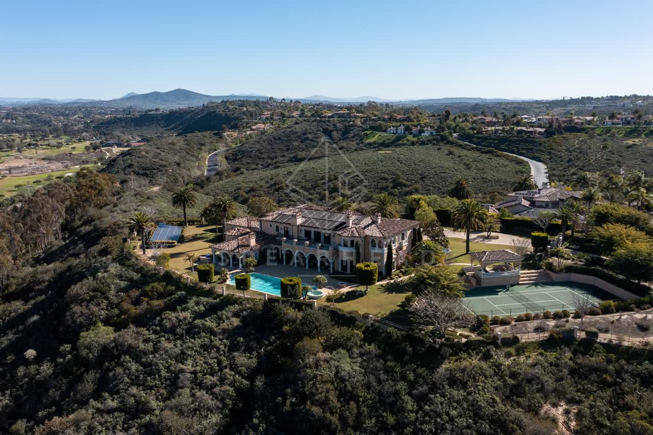 Aerial view of a residential street, palm trees and homes at Rancho Pacifica.