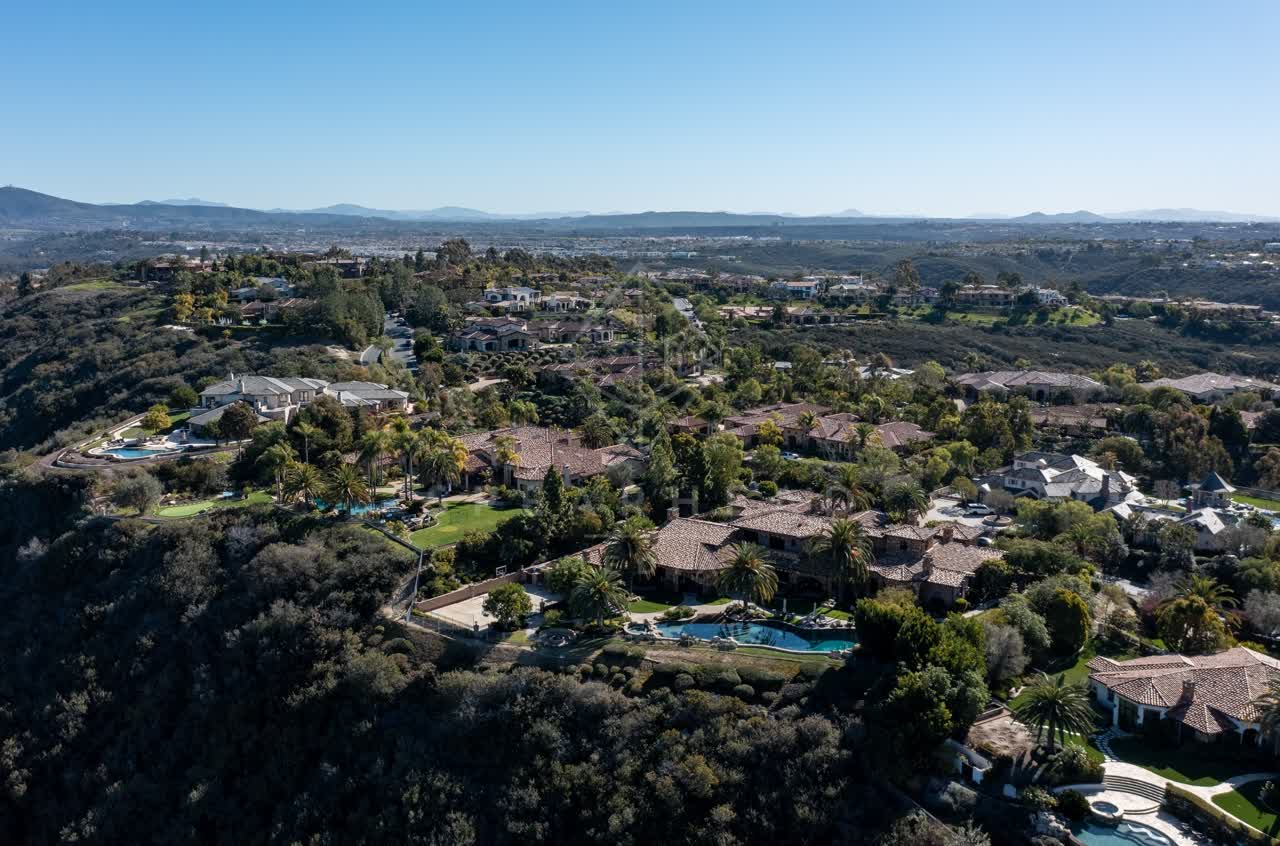 Aerial view of a residential street, palm trees and homes at Rancho Pacifica.