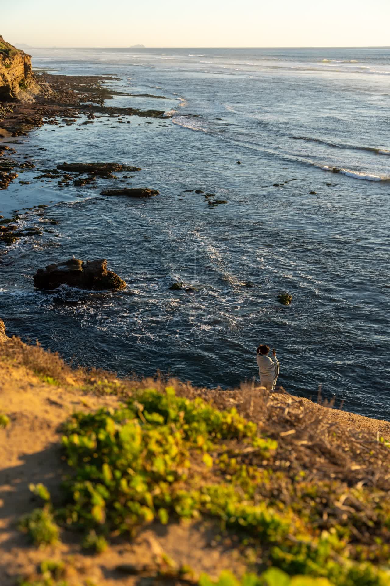 Elevated view of the cliffs, the ocean and open country at Sunset Cliffs.