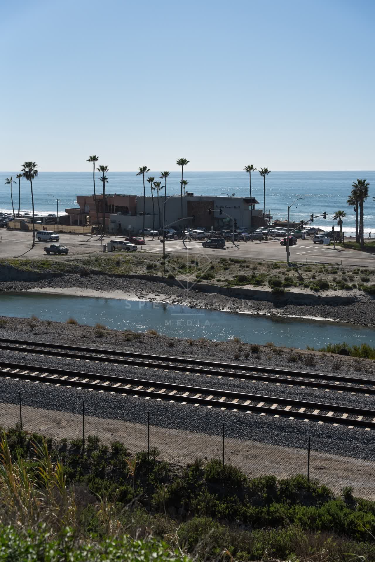 Elevated view of the beach, the surf and palm trees in Cardiff.