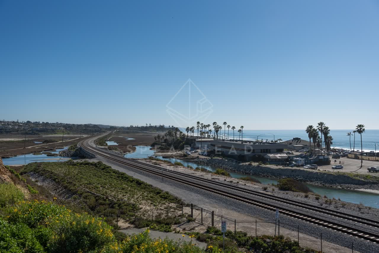 Elevated view of the country inland, palm trees and the ocean in Cardiff.