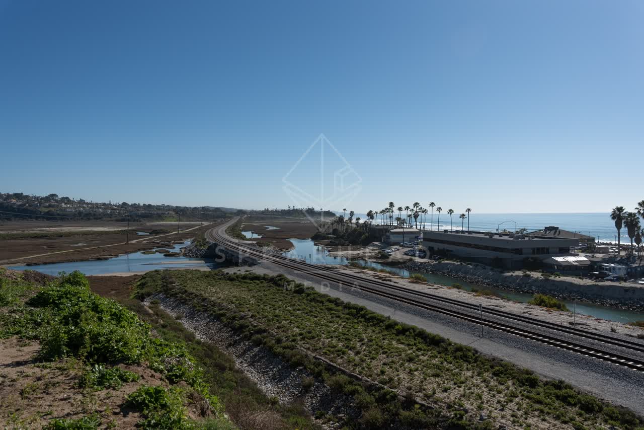 Elevated view of the country inland, palm trees and the ocean in Cardiff.