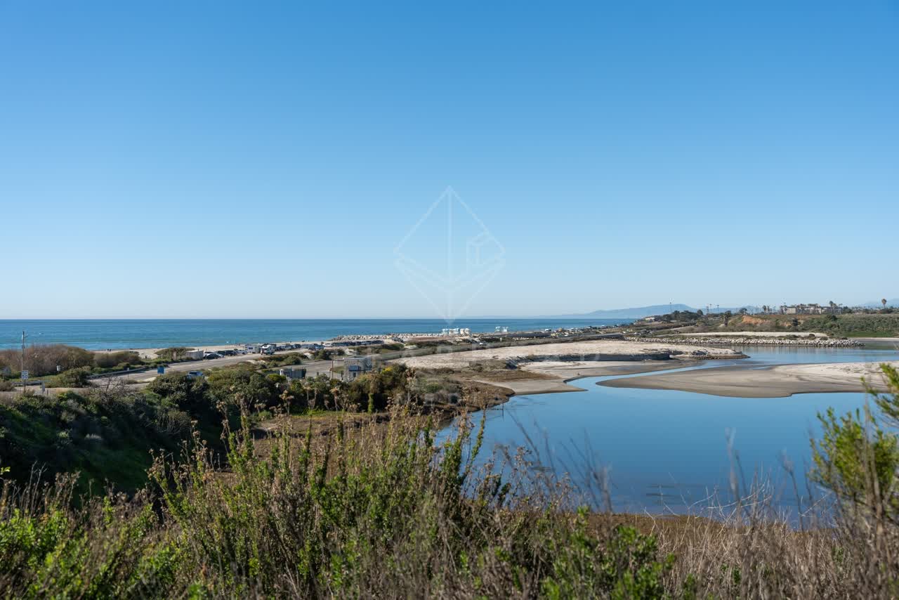 Elevated view of the beach, the ocean and open country in Cardiff.