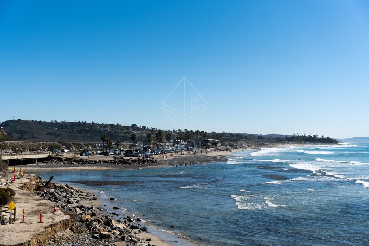 Elevated view of the beach, the surf and palm trees in Cardiff.