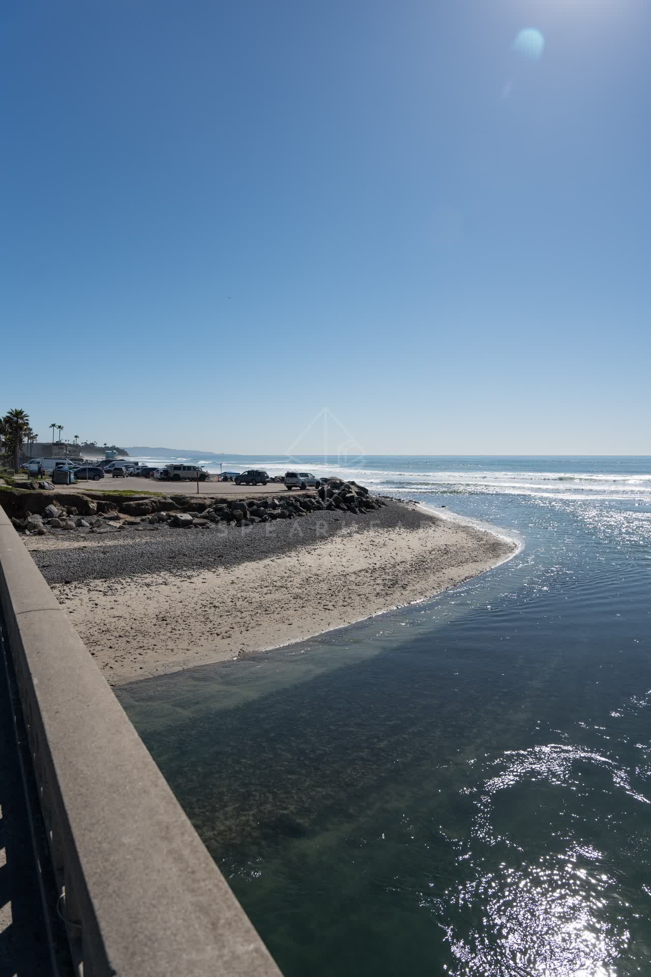 Elevated view of the beach, the surf and palm trees in Cardiff.