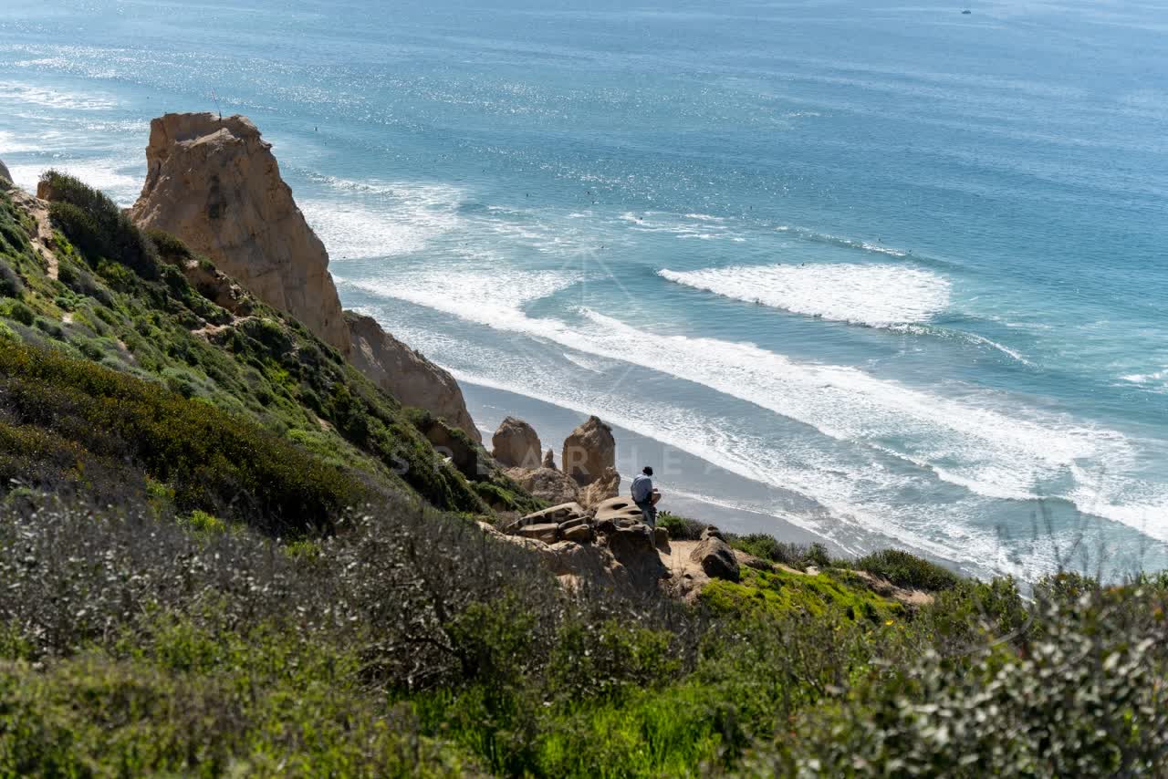 Elevated view of the cliffs, the surf and the ocean at Torrey Pines.