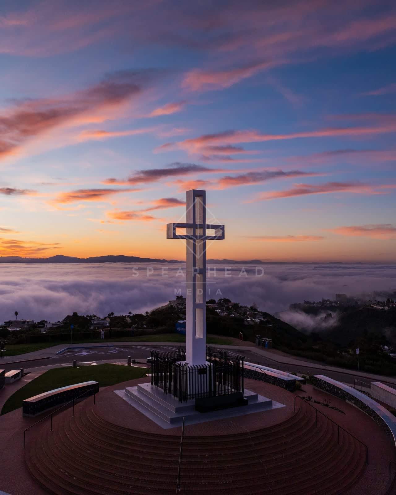 Low aerial view of the cliffs, homes and open country at Mount Soledad.