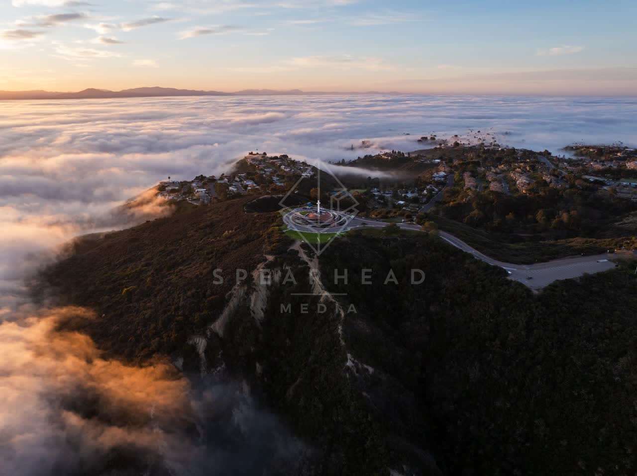 Aerial view of a residential street, homes and open country at Mount Soledad.