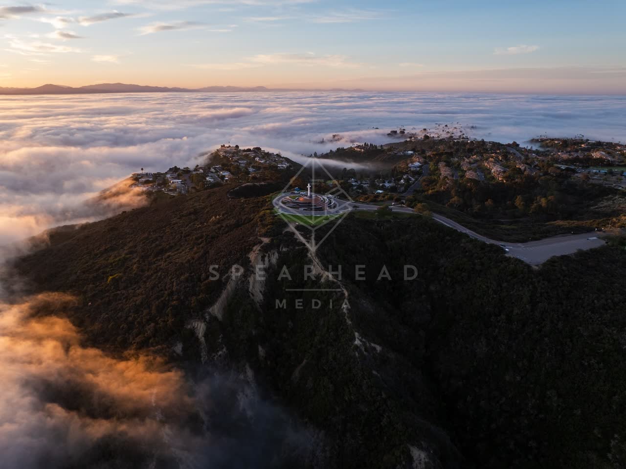 Aerial view of a residential street, homes and open country at Mount Soledad.