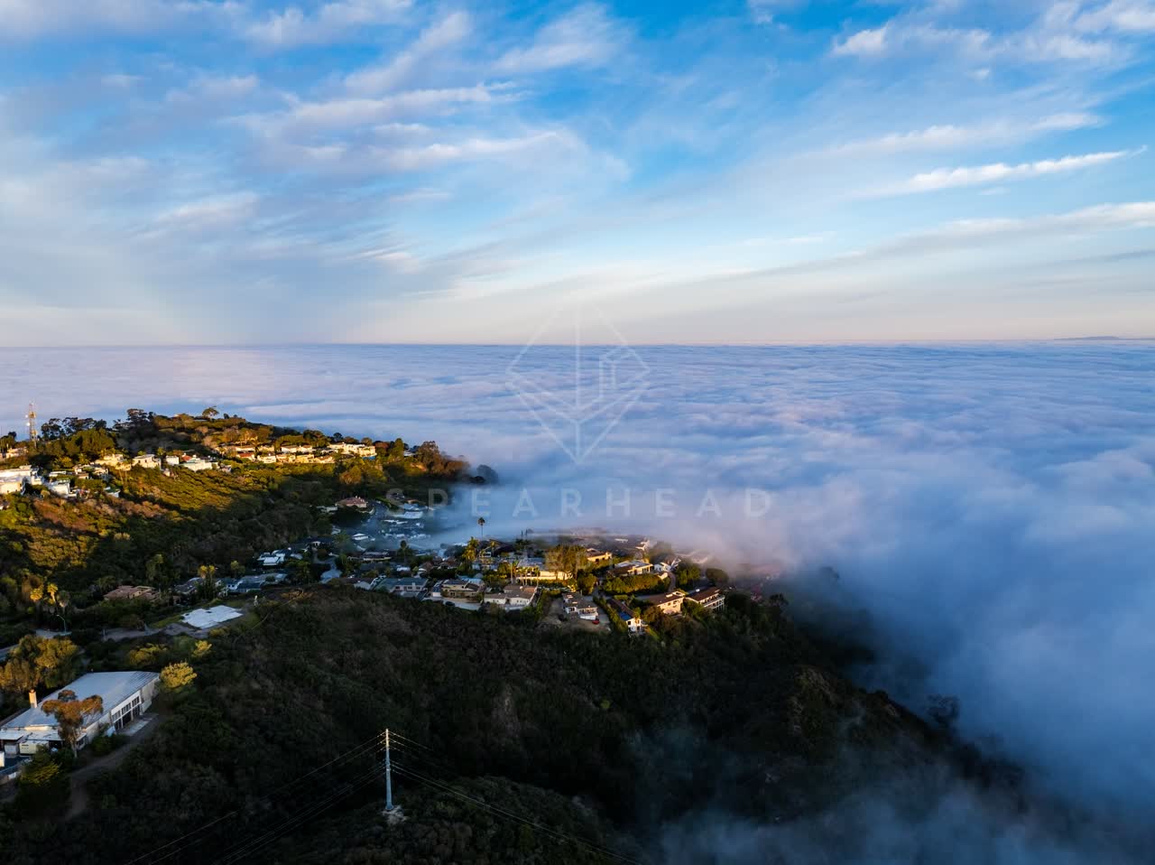 Aerial view of a residential street, homes and open country at Mount Soledad.