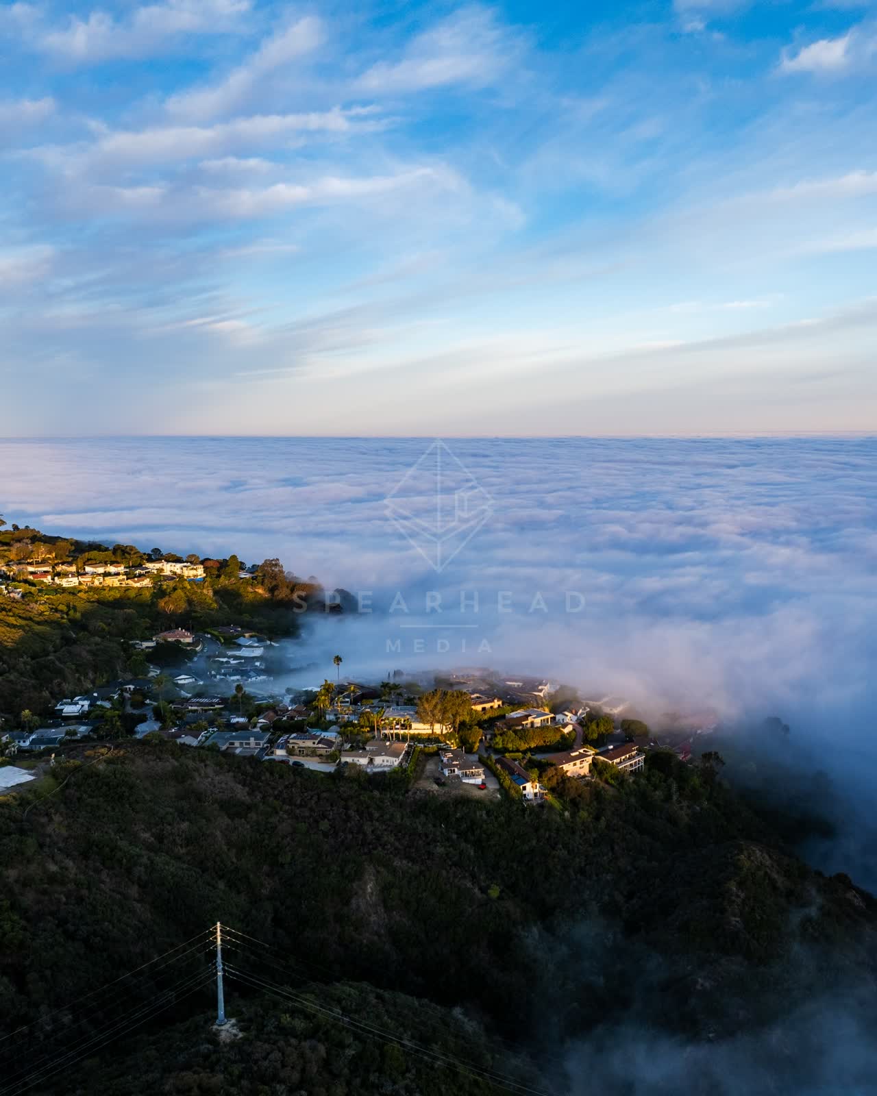 Aerial view of a residential street, homes and the cliffs at Mount Soledad.