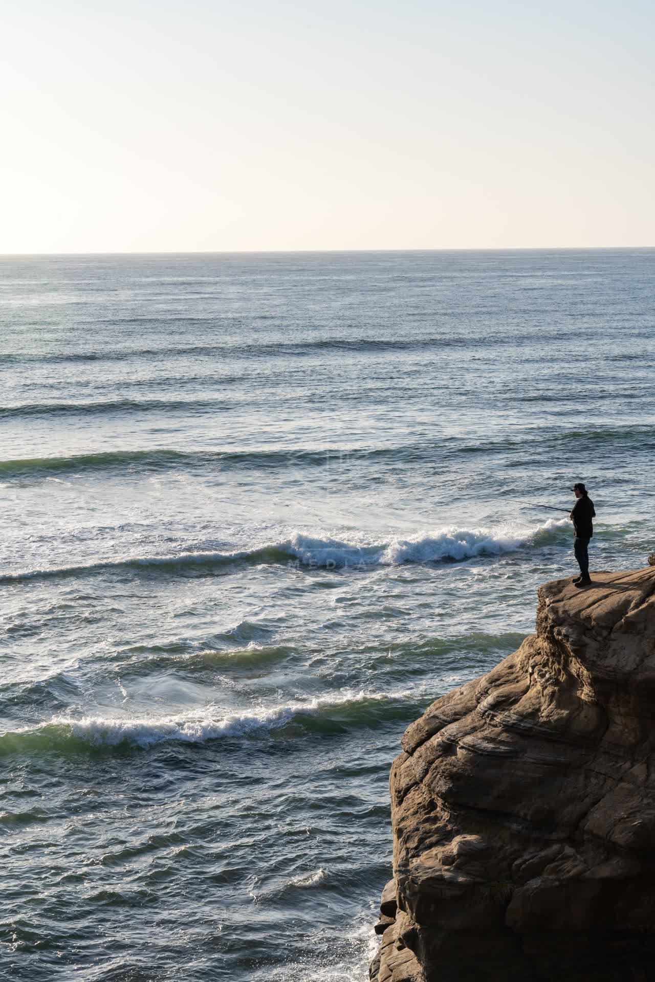 Elevated view of the cliffs, the surf and the ocean at Sunset Cliffs.
