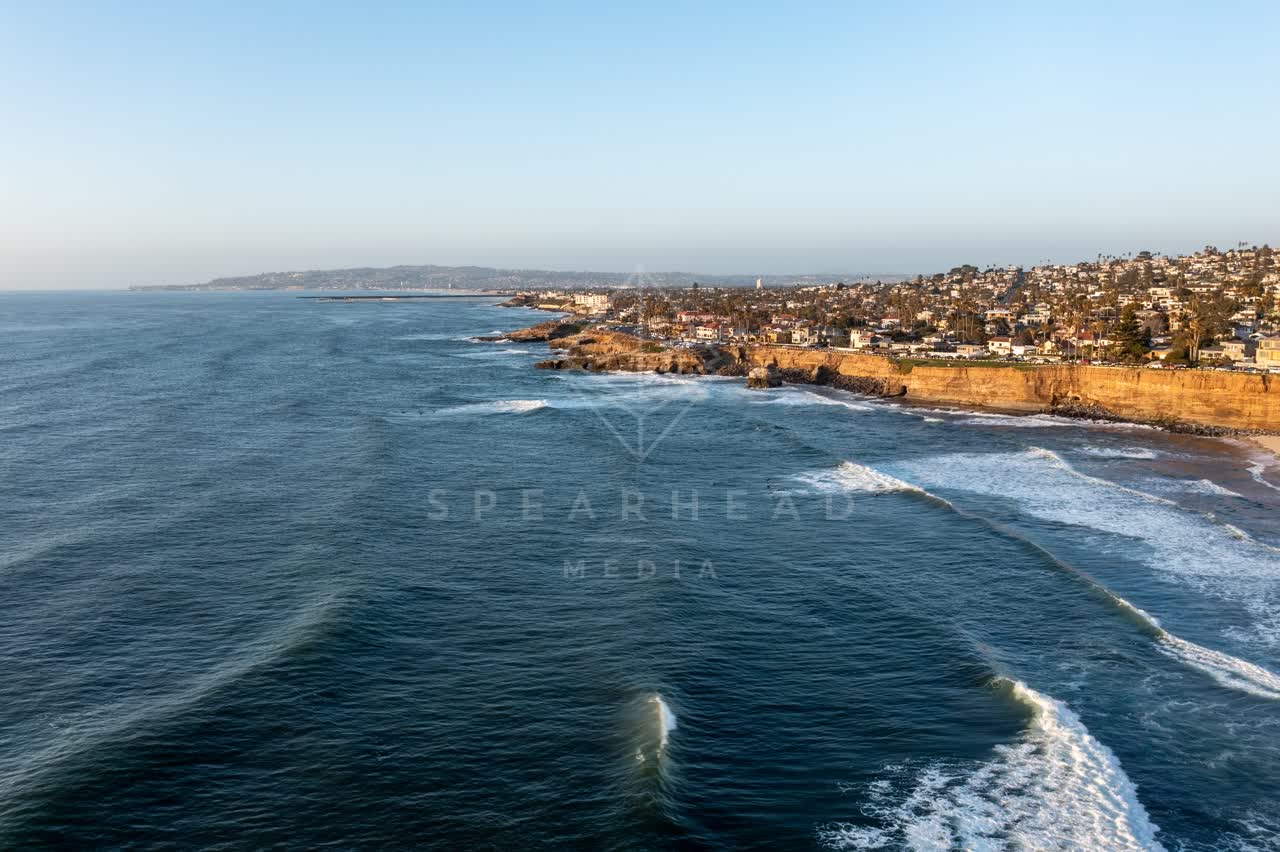 Aerial view of the cliffs, the surf and the ocean at Sunset Cliffs.