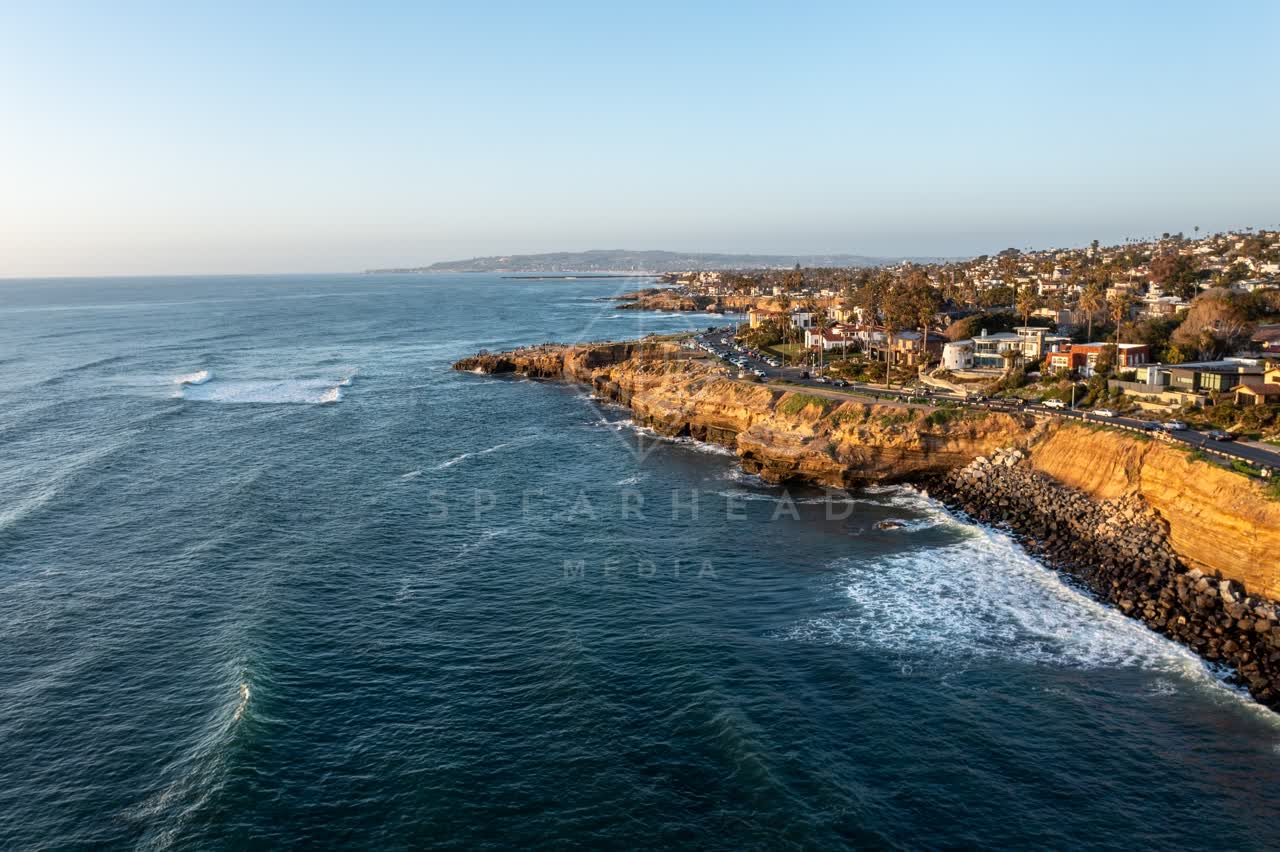 Aerial view of the cliffs, the surf and the ocean at Sunset Cliffs.