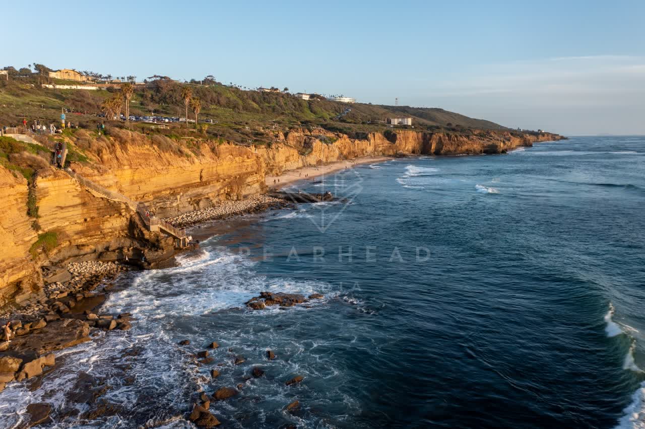 Aerial view of the cliffs, the surf and palm trees at Sunset Cliffs.