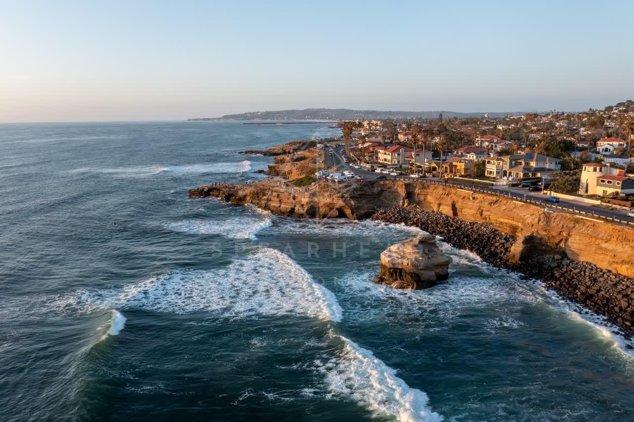 Aerial view of the cliffs, the surf and palm trees at Sunset Cliffs.