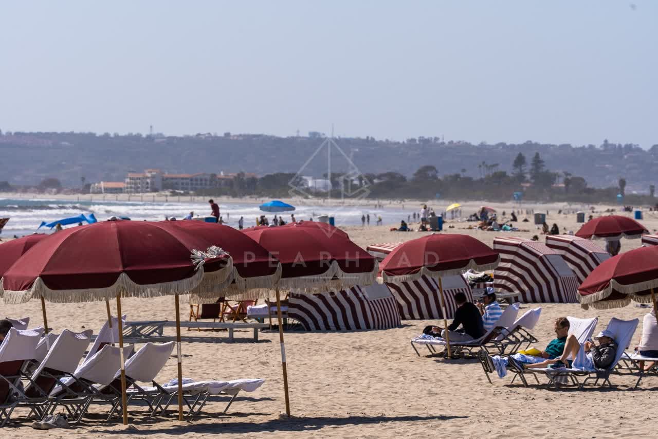 The beach, the ocean and open country at Coronado Beach, with people walking.