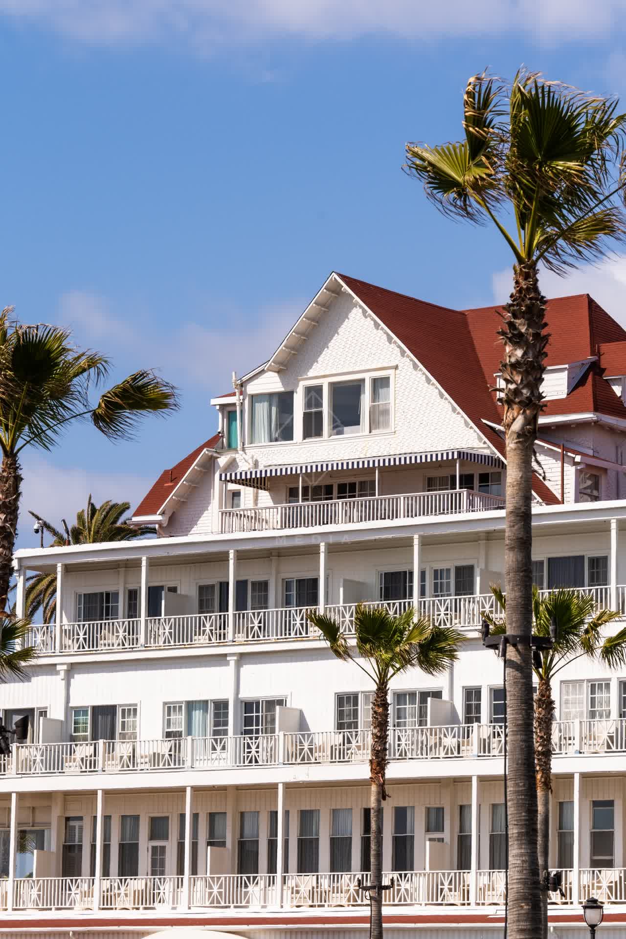 The beach, palm trees and the buildings at Coronado Beach.