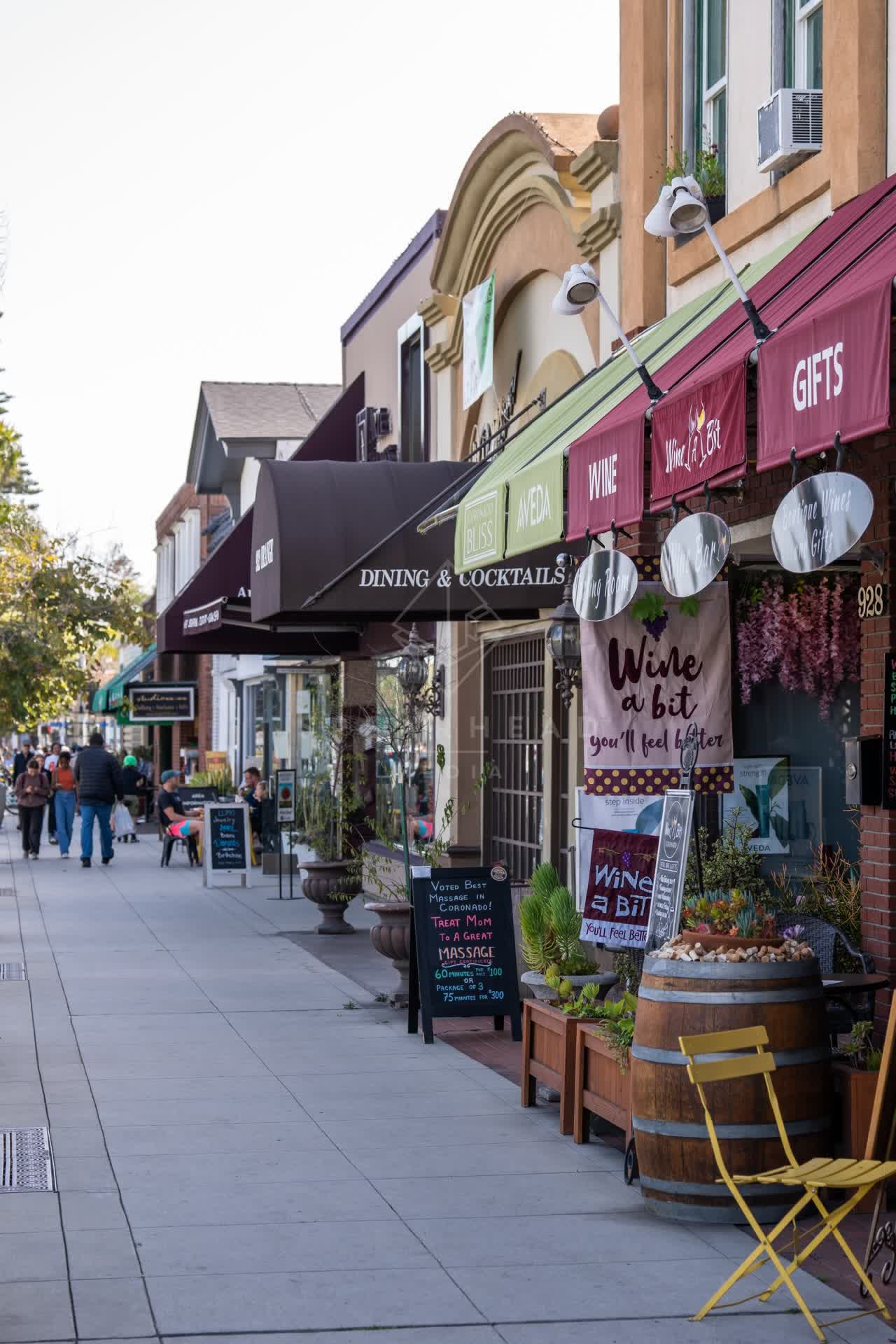 The downtown streets, homes and the buildings in Coronado, with people walking.