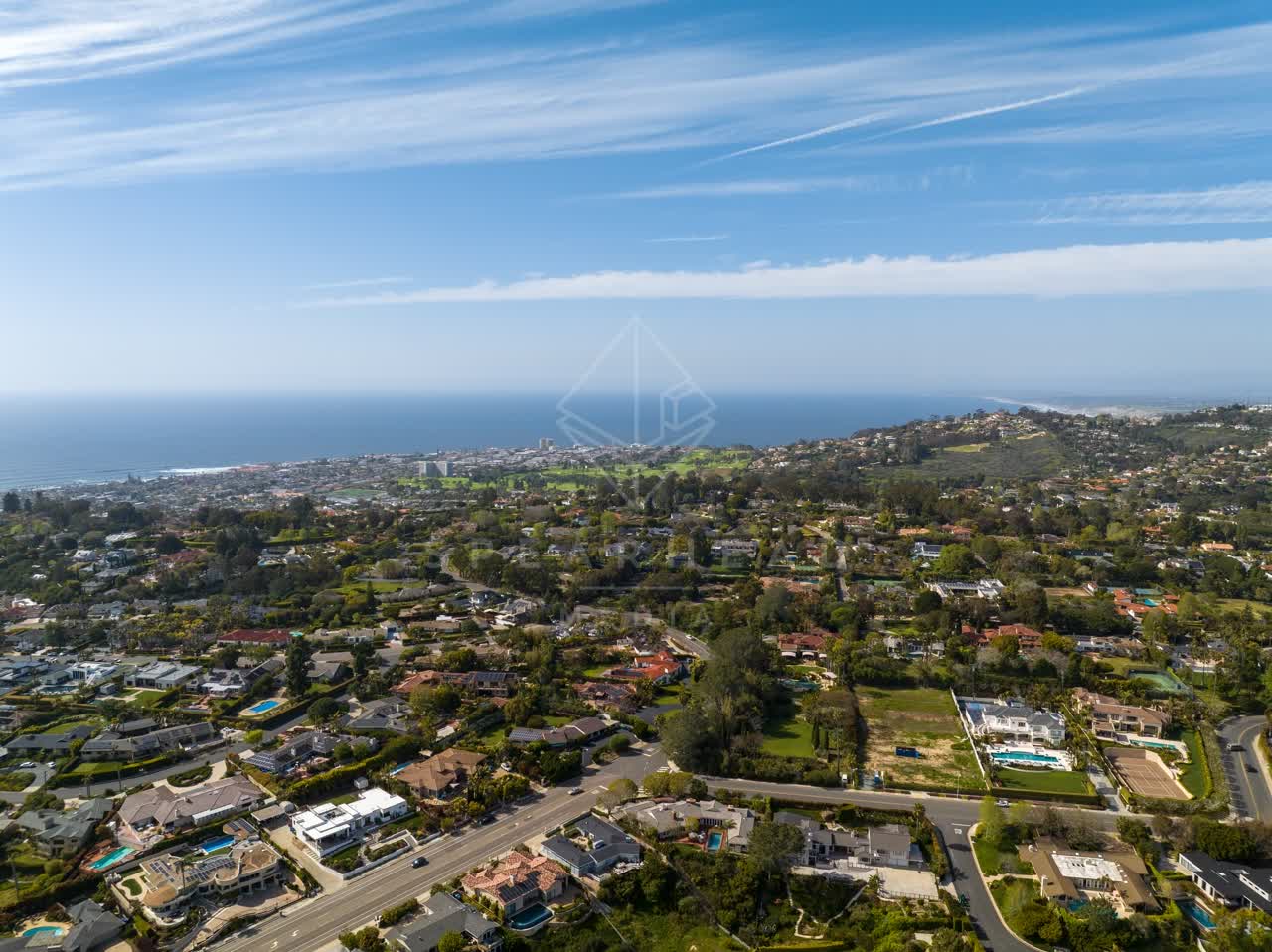 Aerial view of a residential street, the ocean and homes at La Jolla Mesa.