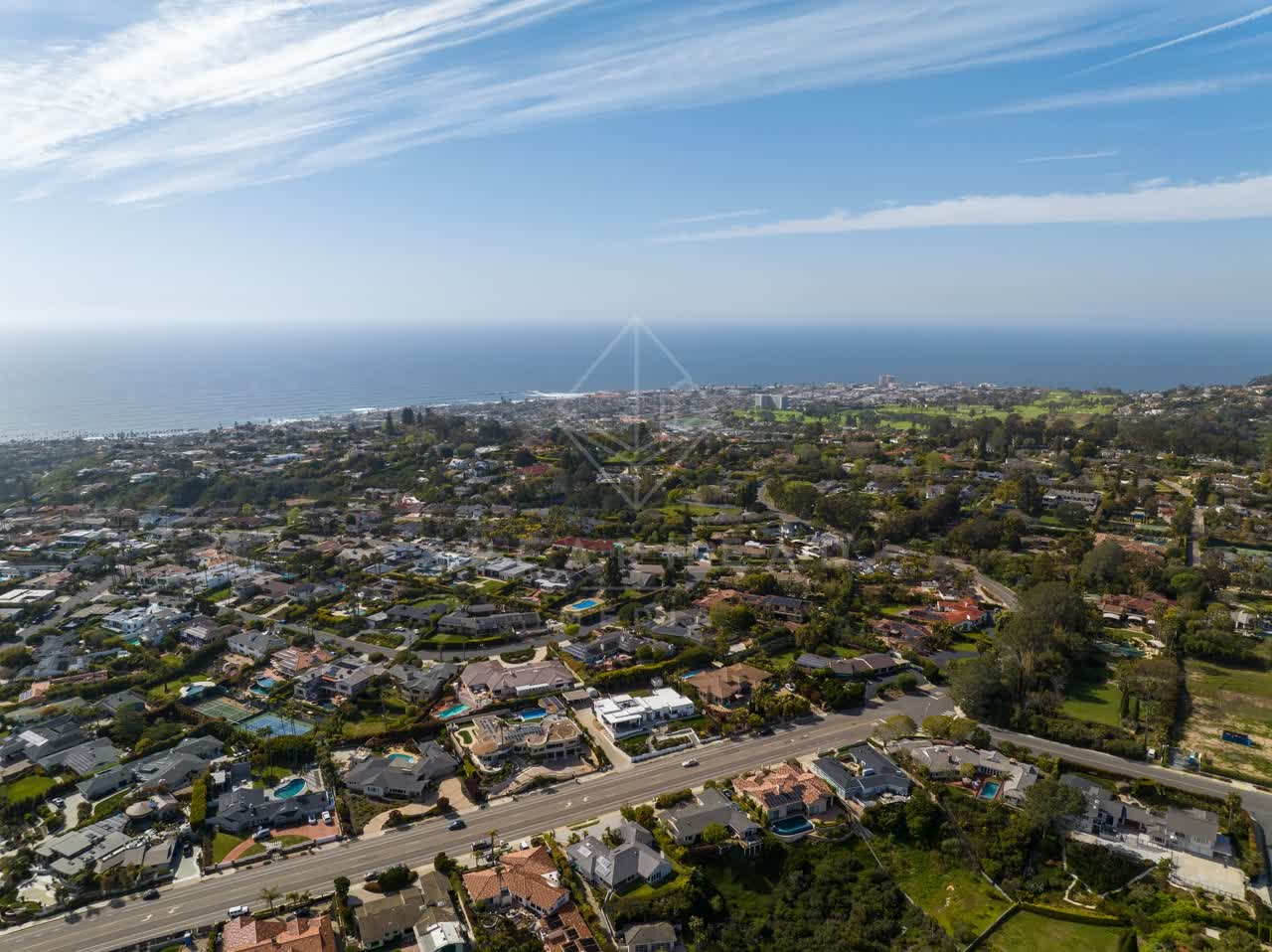 Aerial view of a residential street, the ocean and homes at La Jolla Mesa.