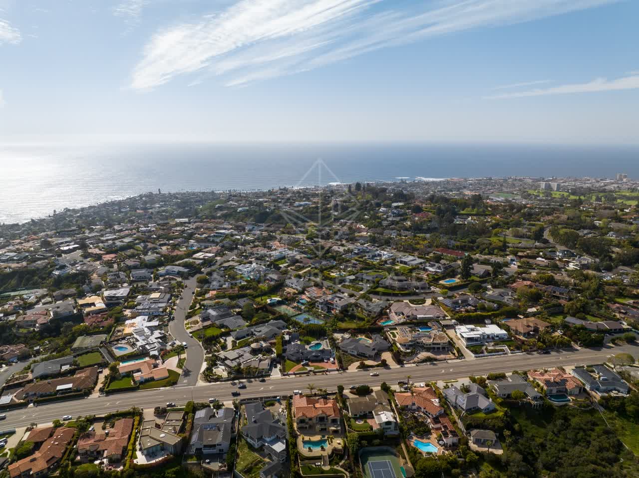 Aerial view of a residential street, the ocean and homes at La Jolla Mesa.
