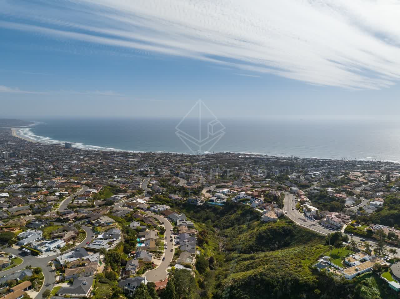 Aerial view of a residential street, the ocean and homes at La Jolla Mesa.