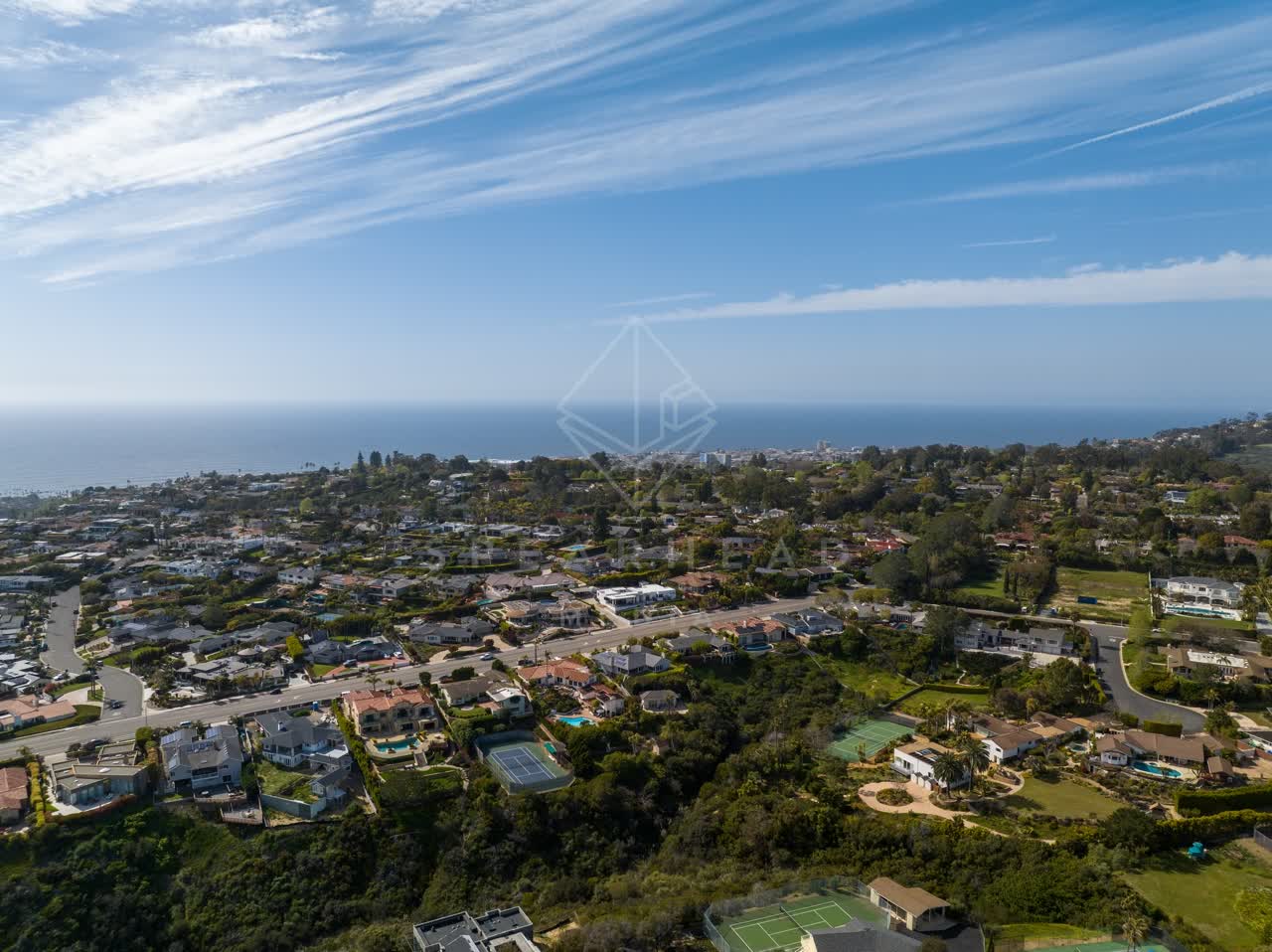 Aerial view of a residential street, the ocean and homes at La Jolla Mesa.