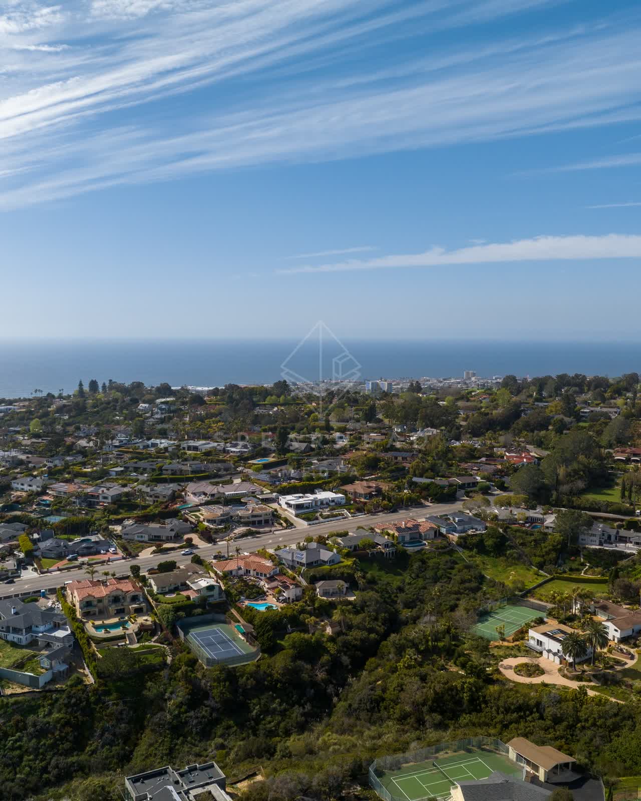 Aerial view of a residential street, the ocean and homes at La Jolla Mesa.