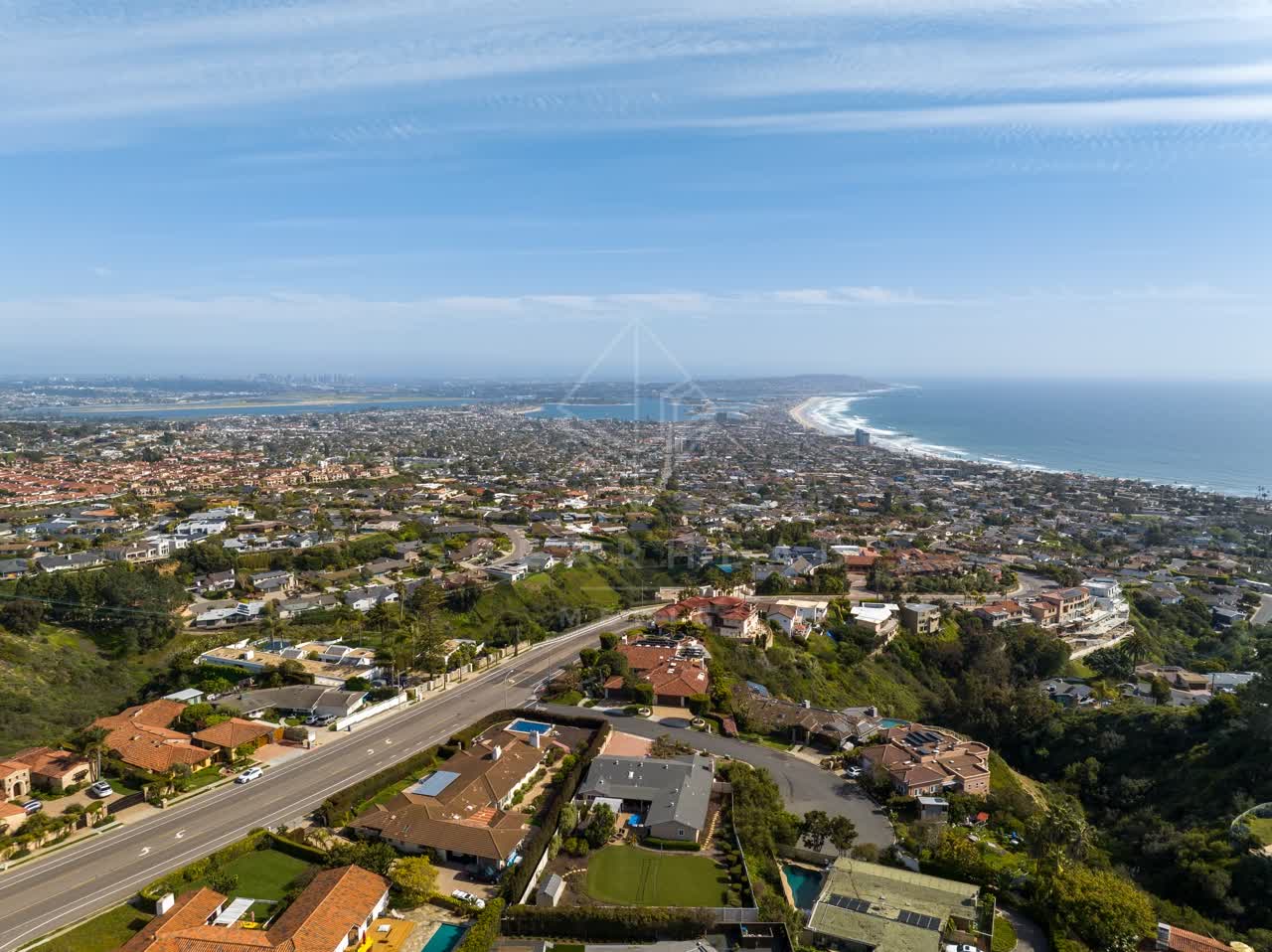 Aerial view of a residential street, the ocean and homes at La Jolla Mesa.
