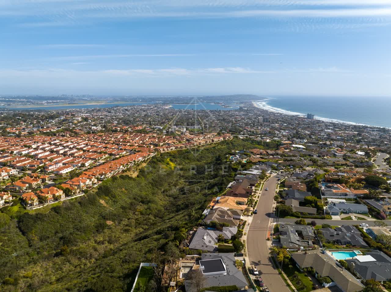 Aerial view of a residential street, the ocean and homes at La Jolla Alta.