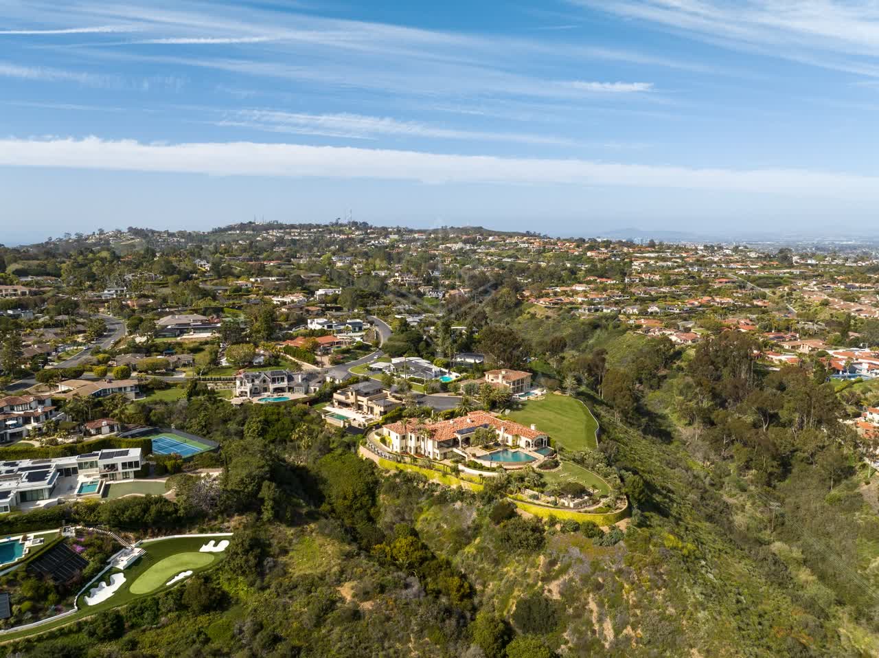 Aerial view of a residential street, homes and the buildings at La Jolla Mesa.