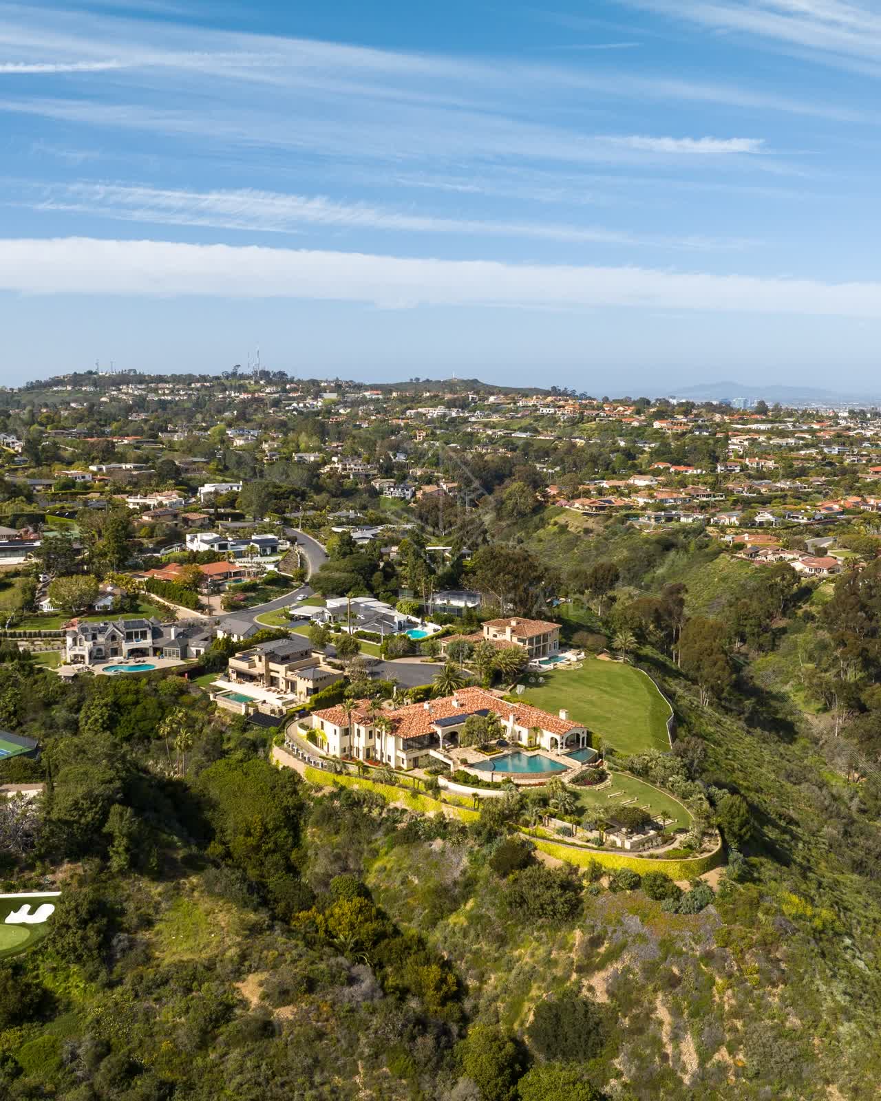 Aerial view of a residential street, homes and the buildings at La Jolla Mesa.