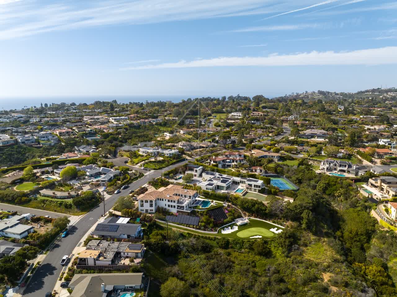 Aerial view of a residential street, the ocean and homes at La Jolla Mesa.