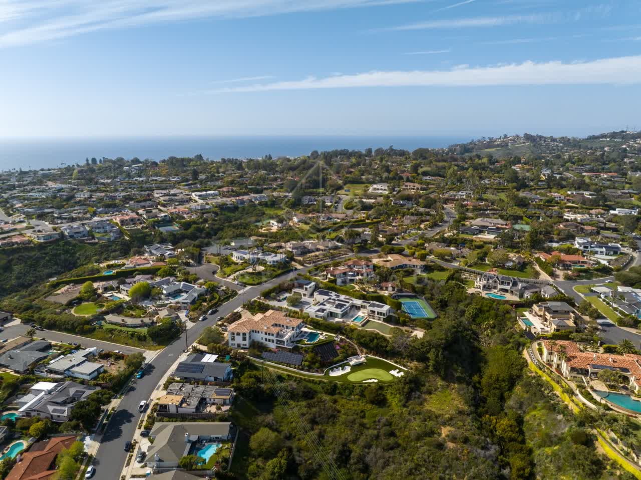Aerial view of a residential street, the ocean and homes at La Jolla Mesa.