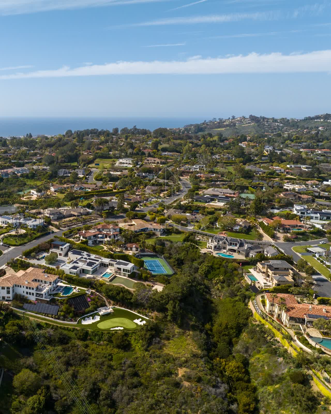 Aerial view of a residential street, the ocean and homes at La Jolla Mesa.