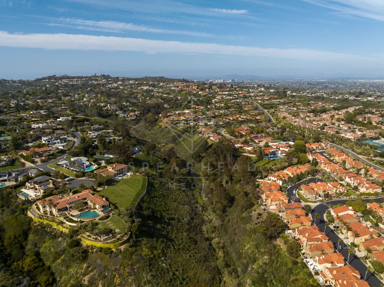 Aerial view of a residential street, homes and the buildings at La Jolla Mesa.