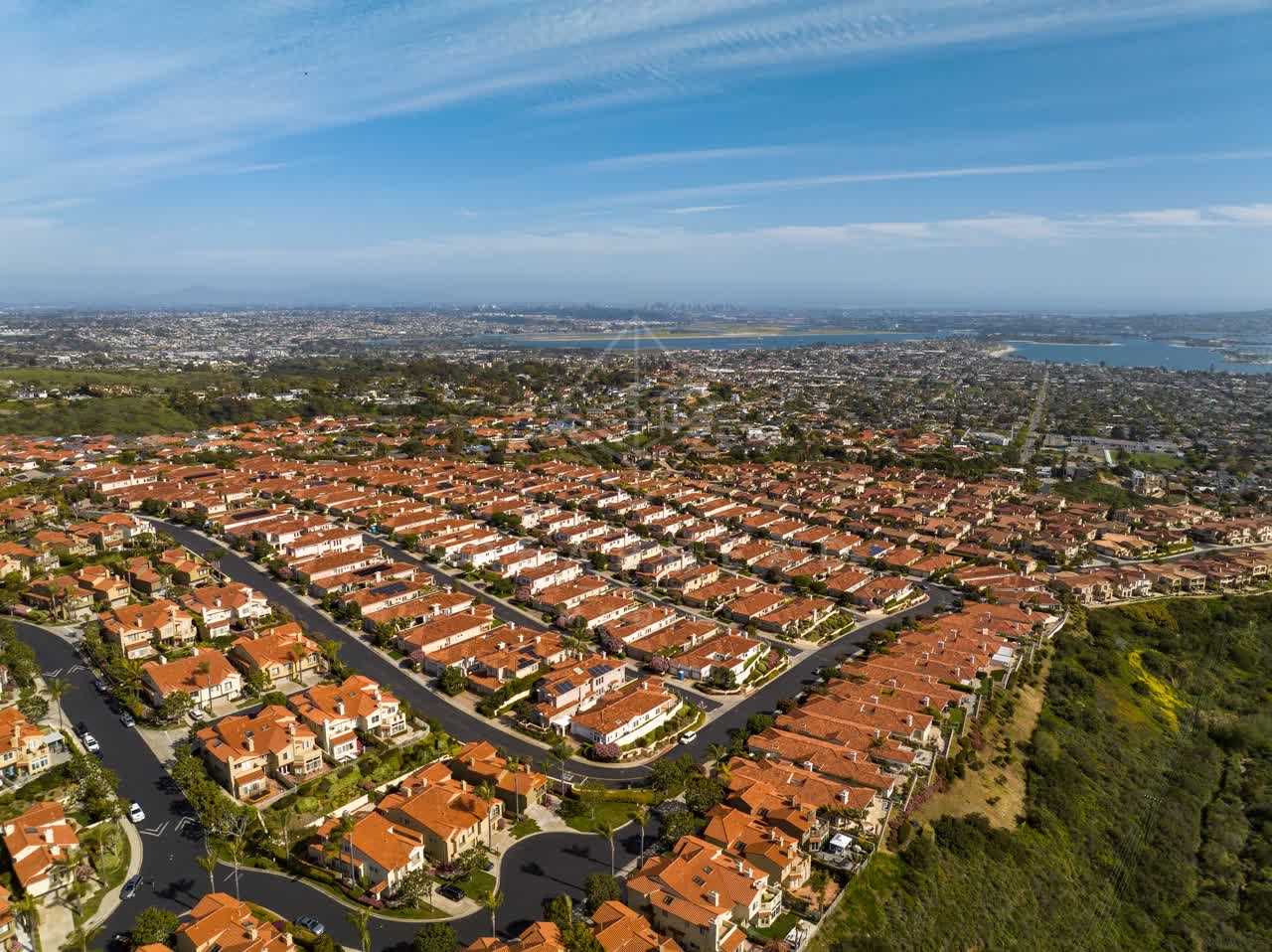 Aerial view of a residential street, the bay and homes at La Jolla Alta.