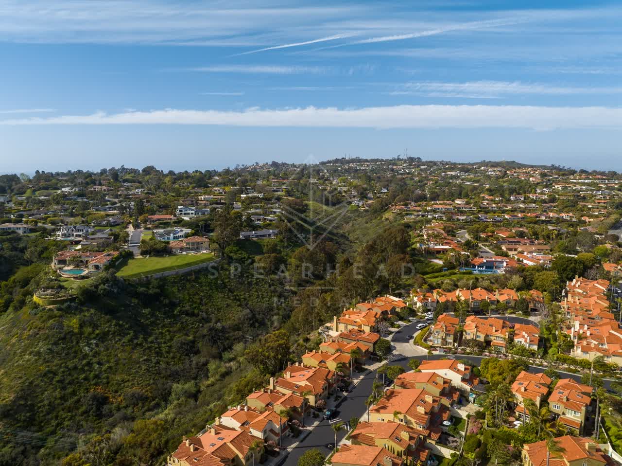 Aerial view of a residential street, homes and the buildings at La Jolla Alta.