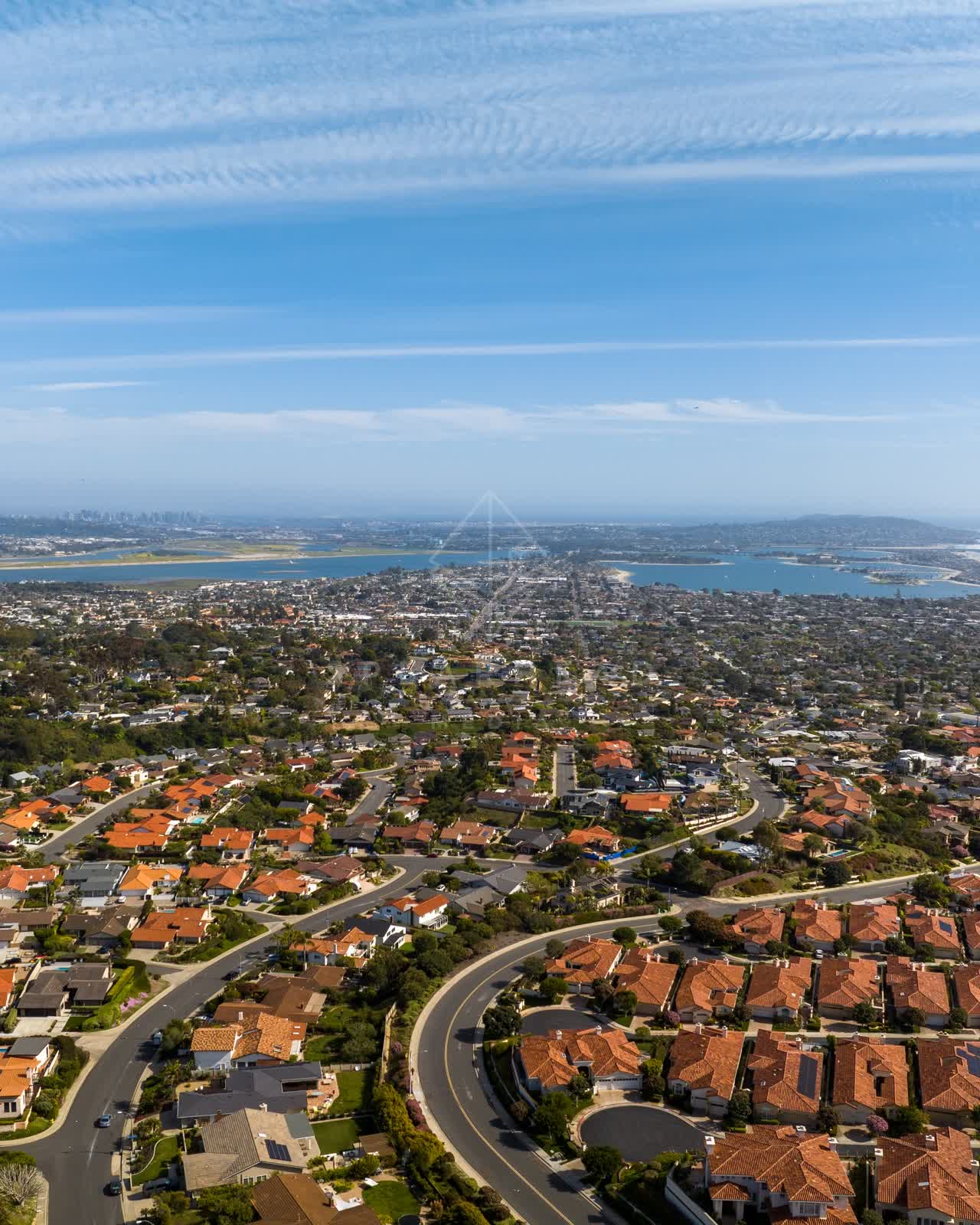 Aerial view of a residential street, the skyline and the bay at La Jolla Alta.