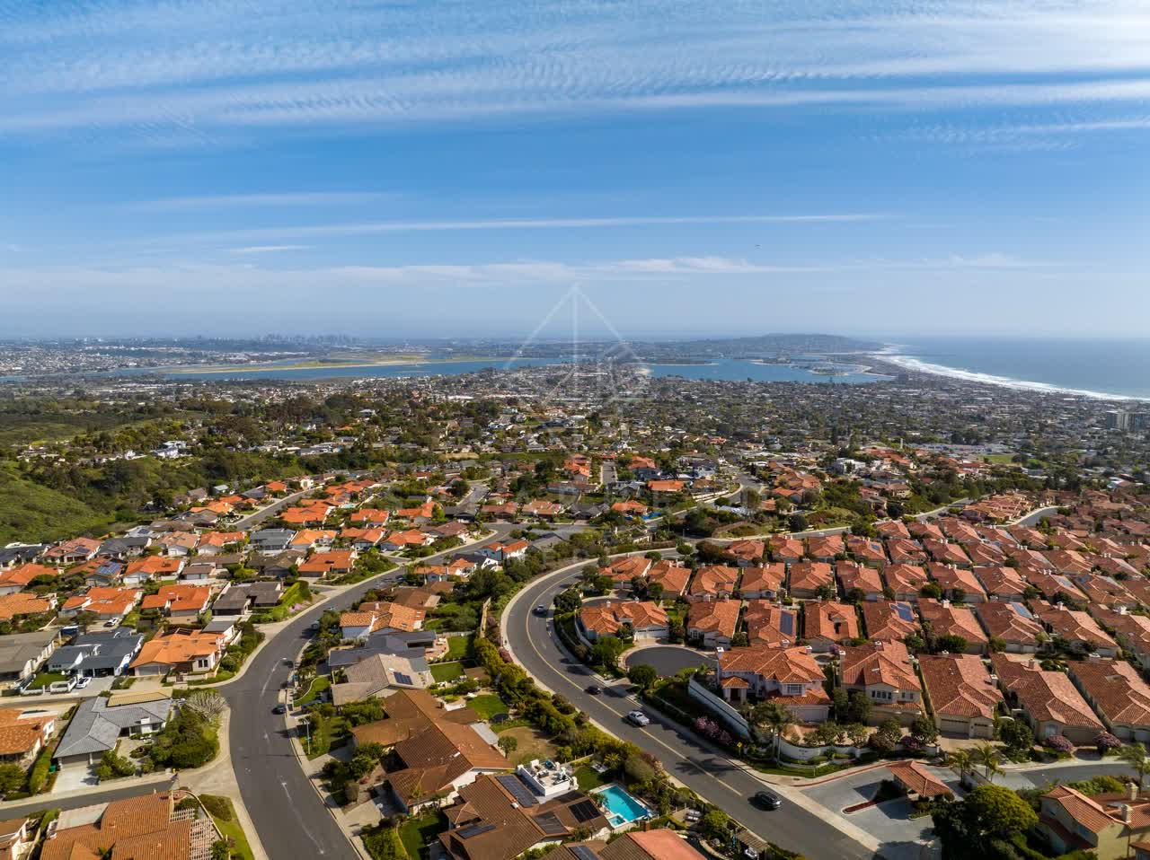 Aerial view of a residential street, the skyline and the ocean at La Jolla Alta.